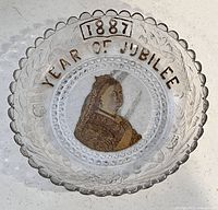 Top view showing full plate with text '1887 YEAR OF JUBILEE' and central Queen Victoria portrait with gold detailing.