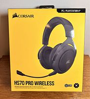 Front of the original yellow and black Corsair HS70 Pro Wireless headset box showing product image and branding.