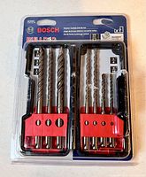 Front view of new, never opened Bosch Bulldog hammer carbide drill bit set showing 7 drill bits secured in clear packaging.