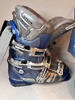 Side view of blue and silver Tecnica Ultra Fit ski boots showing buckles and padded inner lining.