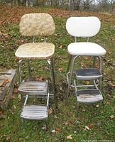 Front view of two chair step stools outdoors, showing upholstery and metal steps with visible rust