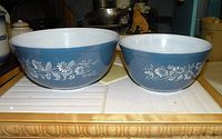 Two Pyrex bowls side by side showing the Colonial Mist blue floral pattern, different sizes #402 and #403.