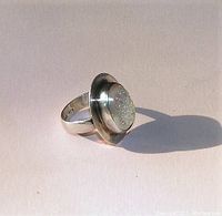 Silver ring with oval sparkling druzy-style stone and FNA .925 marking.