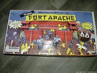 Top view of the Fort Apache playset in original box with colorful graphics depicting the set fully assembled with blue and yellow figures and horses.