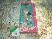 1988 Skating Star Barbie doll in original box shown from front, secured in packaging with skating dog accessory and winter-themed background.