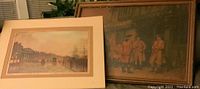Wide view of both art pieces showing colonial tavern painting and matted print