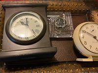 Three clocks displayed together: Restoration Hardware mantel clock, Marquis by Waterford crystal clock, white Westclox Big Ben clock