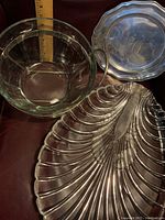 Top-down photo showing all three items together: the lobster platter, glass bowl, and silverplate caddy tray with a measuring stick to indicate size.