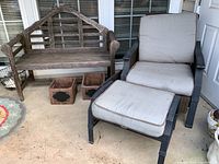 Wood bench and Hampton Bay chair with ottoman with cushions shown on patio floor