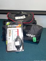 Canon camera case and Ledgo pouch at rear, cleaning kit in front