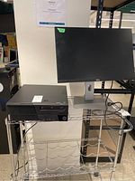 Front view of Lenovo desktop and Dell monitor on shelving unit