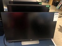 Front view of three Dell U275Hc monitors on adjustable stands