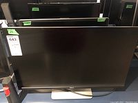 Front view of three Dell monitors on desk