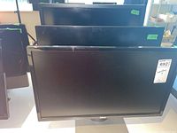 Three Dell monitors displayed front and rear.