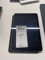 Two stacked Apple iPad tablets with MaxSold lot sticker labeled 'iPad 2' on top iPad