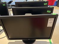 Front view of 3 BenQ monitors stacked, black screens off, showing measurement stickers and MaxSold tag.