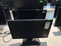 Front view of one Acer monitor on a desk with power cable 