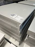 Stack of five Cisco Meraki MS220-48LP switches in silver rack-mount chassis; top unit bears lot sticker