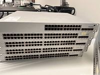 Stacked front view showing four 48-port switches and one 24-port switch with RJ45 ports