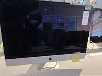 Front view of 27-inch iMac powered off showing display and integrated stand