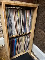 Full view of two-shelf unit filled with vinyl LPs