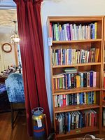 Photo showing five shelves filled with books of various sizes and colors, highlighting the variety in the collection.