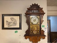 Both clock and raccoon print hanging on wall