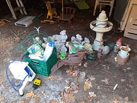Overview of lot showing assorted garden ornaments, planters and accessories on ground