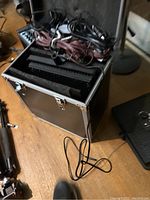 Open hard case with cables and two LED panel lights visible.
