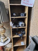 Zoom H4n Handy Recorder displayed on wooden shelving with other items.