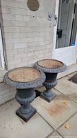 Two urn planters side by side on front porch, showing shape and paired display