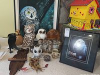 Wide view of grouped owl decor on floor and table