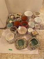 Overview of 23 assorted planter pots in various styles, materials, and colors