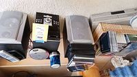 Stereo system with speakers, VHS player, CDs and DVDs on shelf