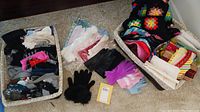 Overview showing two baskets: one filled with assorted socks, pink, black and gray, another basket containing textiles, crochet pieces, and gloves in multiple colors.