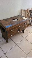 Wooden storage box from an angled front side showing drawers and the heart-shaped cutout on top.