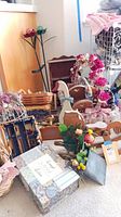 Photo showing multiple wooden decorative items including bird cages, floral wreaths, baskets, and small furniture pieces.