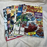 Photo showing six different comic books with colorful vintage covers.