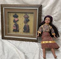 Photo showing the framed cultural shadowbox and the ethnic doll side by side