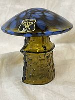 Side view showing blue spotted amber cap and textured amber stem with original Golden Crown E & R Sweden label on cap.