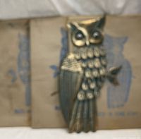 Front view of threaded metal owl wall sculpture with detailed feather work and moving eyes, showing patina of brass/bronze tone.