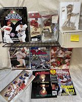 Full view of lot with various Phillies memorabilia displayed including yearbooks, baseball cards, and figurines.