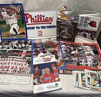 View of assorted Phillies memorabilia including posters, trading cards, figurine, and book.