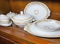 Photo showing full set of 7 pieces including platters, lidded serving bowl, serving bowl, sugar bowl, and gravy boat with underplate