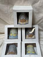 Five fabric-covered night lights in white box packaging, showing Easter chick and bunny designs
