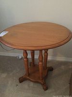Top view of the round wooden end table showing smooth surface and rounded edge.
