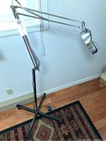 Full view of the magnifier on its stand showing adjustable arm and base.