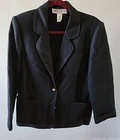 Front view of black women's jacket by Weinberg Paris showing two metallic buttons, notch lapels, two lower pockets and chest pocket.