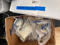 Box containing multiple baby monitors and their cords, labeled 'Baby Monitors'.