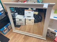 Full front view of the large rectangular wall mirror with white frame showing its proportions and condition.